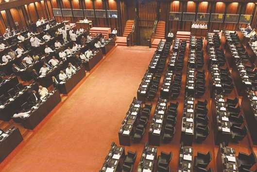 Members of Sri Lankau2019s sacked prime minister Ranil Wickremesingheu2019s party (left) sit in the parliament chamber as President Maithripala Sirisenau2019s party boycotts the parliament session in Colombo yesterday.