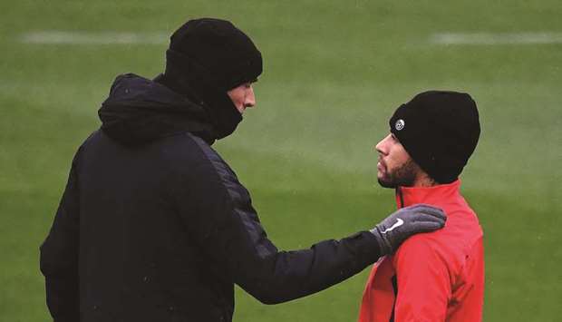 Paris Saint-Germainu2019s Brazilian forward Neymar (R) speaks with head coach Thomas Tuchel during a training session in Saint-Germain-en-Laye, west of Paris, yesterday.