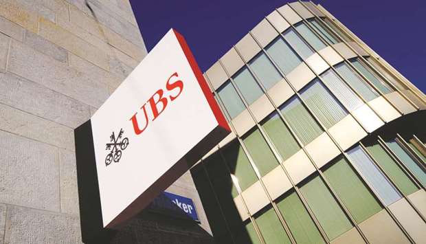 A UBS logo is displayed on a sign outside its branch in Zurich, Switzerland. International banks such as UBS and Credit Suisse are battling to hire wealth managers with portfolios worth hundreds of millions of dollars to gain a bigger share of Asiau2019s rapidly expanding pool of millionaires.
