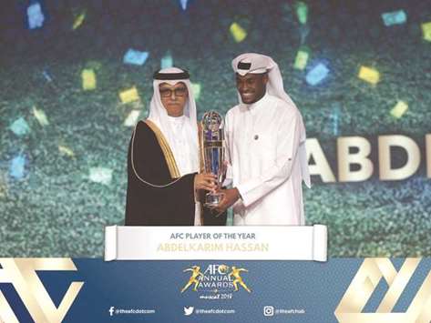Qatar and Al Saddu2019s Abdelkarim Hassan (R) receives his AFC Player of the Year award from AFC President Sheikh Salman bin Ebrahim al-Khalifa in Muscat yesterday.