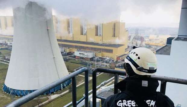 A Greenpeace activist after he climbed a 180 metre-high chimney at Poland's Belchatow coal-fired power plant Belchatow