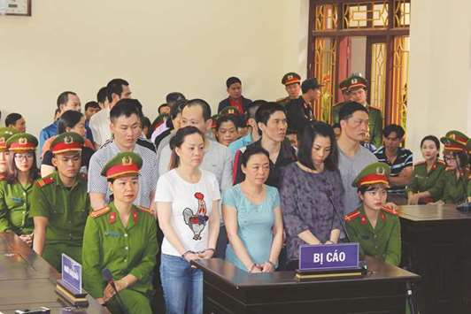 Defendants charged with illegal drug dealing and possession stand during a trial in a court in Vietnamu2019s Ha Nam province yesterday.