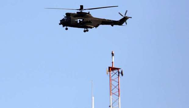 A NATO helicopter flies over the Resolute Support headquarters in Kabul, Afghanistan