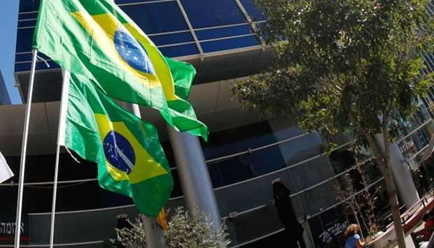 Brazilian flags hang outside the building housing the offices of the Brazilian Embassy