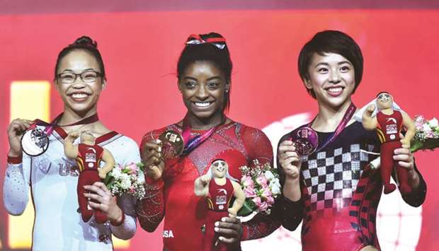 Winner Simone Biles (centre) poses with second-placed Morgan Hurd (left) of the US and third-placed Mai Murakami of Japan during the medals ceremony for the womenu2019s Floor Exercise yesterday.