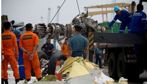 Indonesian rescue personnel unload a recovered engine from the ill-fated Lion Air flight JT 610 at a port in Jakarta