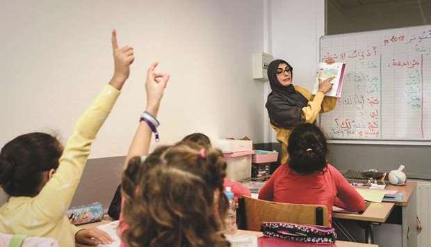 This photograph taken on October 3, shows a teacher gesturing during a class of Arabic language for young children at the Institut Lissane private school in Le Kremlin-Bicu00eatre, on the outskirts of Paris.