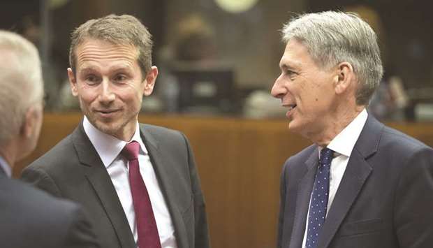 Philip Hammond, UK chancellor of the exchequer (right), speaks with Kristian Jensen, Denmarku2019s finance minister, ahead of a meeting of European Union (EU) finance ministers in Brussels (file). Jensen wants to know why Denmark wasnu2019t warned of the risks by other EU states that were already cracking down on fraudulent claims.