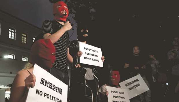 Pro-democracy activist Joshua Wong speaks as he protests alongside members of Pussy Riot from Russia against the jailing of political prisoners, and in support of dissident Chinese-Australian cartoonist Badiucao, who cancelled his exhibition in Hong Kong due to what exhibition organisers claimed were threats from China, in Hong Kong.