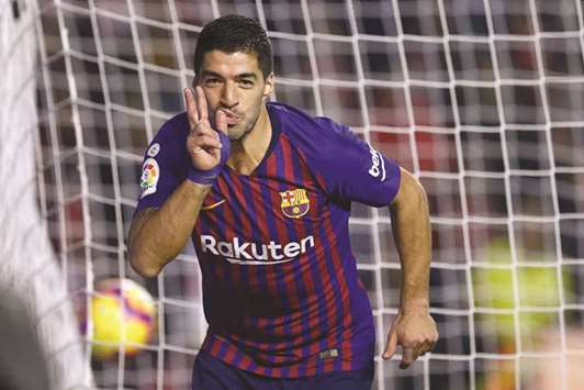 Barcelonau2019s forward Luis Suarez celebrates after scoring a goal against Rayo Vallecano in the La Liga at the Vallecas stadium in Madrid on Saturday. (AFP)