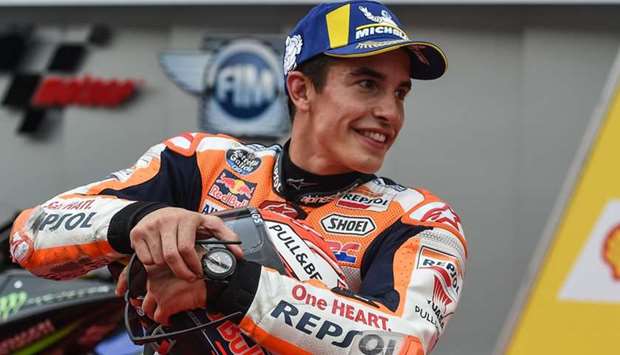 Honda Team's Spanish rider Marc Marquez celebrates after taking the pole position at the qualifying session of the Malaysia MotoGP at the Sepang International Circuit in Sepang yesterday.