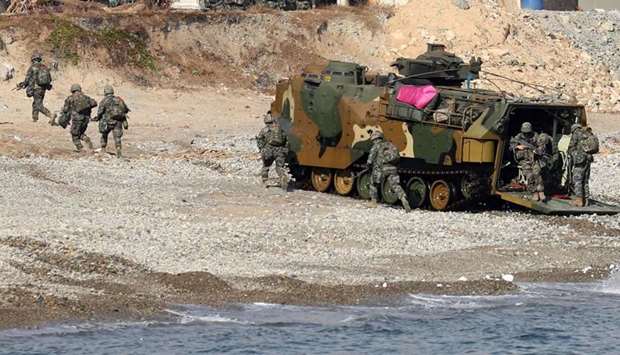 South Korean Marines exit an amphibious assault vehicle on a beach during a landing operation in the southern city of Pohang