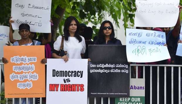 Sri Lankan activists hold placards during a demonstration in Colombo yesterday.