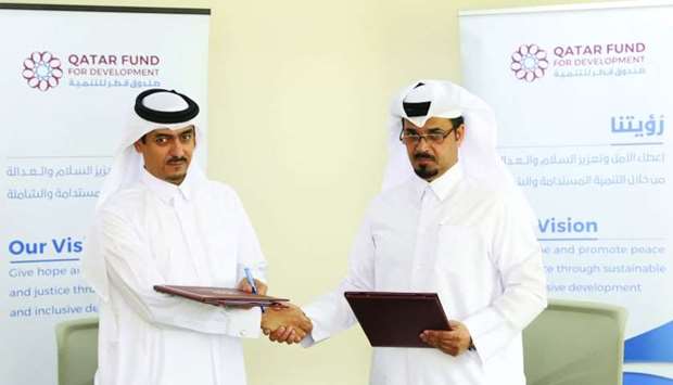 (From left) QFFD executive director for shared services Mansoor Abdullah al-Dehaimi and QRCS executive director Youssef Abdullah al-Sada at the agreement signing.