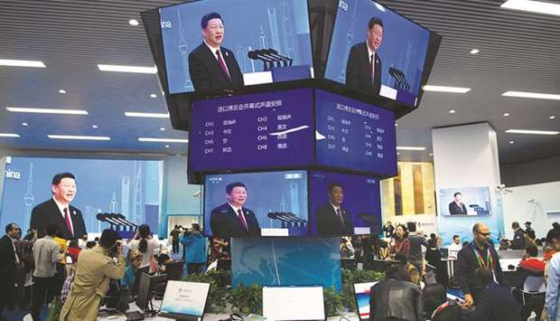 Chinau2019s President Xi Jinping is seen on televisions in the media centre as he speaks at the opening ceremony of the first China International Import Expo in Shanghai. Xi vowed yesterday to open access to Chinau2019s economy, while delivering a veiled rebuke to the Trump administration, as he kicked off an import fair amid growing foreign accusations that his government was backtracking on reform pledges.