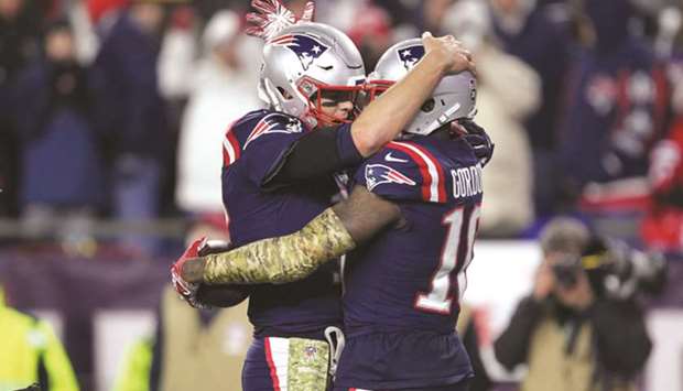 New England Patriots quarterback Tom Brady (left) celebrates his touchdown pass to wide receiver Josh Gordon during the fourth quarter against the Green Bay Packers at Gillette Stadium in Foxborough, Massachusetts, on Sunday. (USA TODAY Sports)