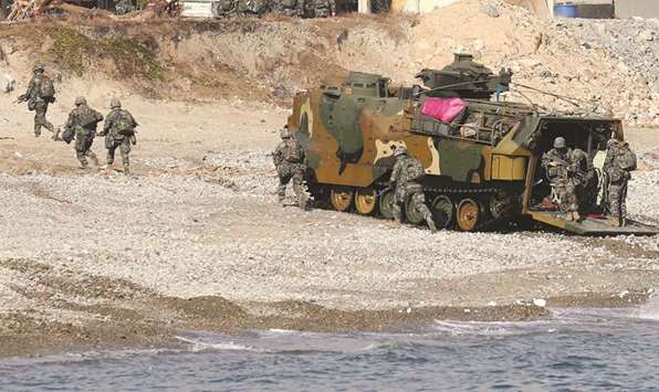 South Korean Marines exit an amphibious assault vehicle on a beach during a landing operation in the southern city of Pohang, South Korea.
