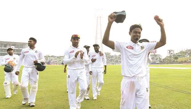 Bangladeshu2019s Taijul Islam (right) acknowledges the crowd after completing his 11-wicket haul on third day of the first Test against Zimbabwe in Sylhet, Bangladesh, yesterday. (AFP)