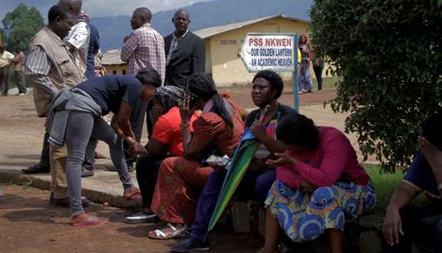 Parents await for news of their children at a school yesterday where 79 pupils were kidnapped in Bamenda, Cameroon