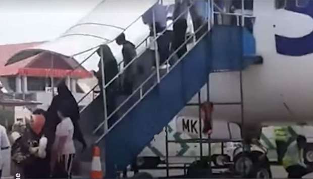 Image grab from a video posted on Facebook by Suaradotcom shows the protesting passenger deboarding the plane.