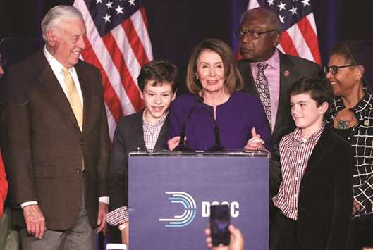US House Minority Leader Nancy Pelosi celebrates the Democrats winning a majority in the US House of Representatives with House Minority Whip Steny Hoyer (left), her grandsons Thomas and Paul and Representative James Clyburn (right rear) during a Democratic election night party in Washington.