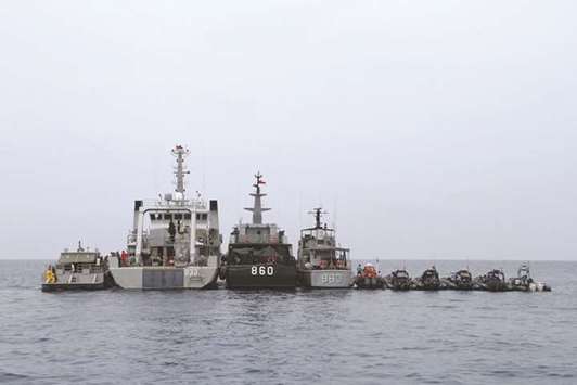 Indonesian navy ships line up during a search operation of the ill-fated Lion Air flight JT 610 victims and debris on the waters off Karawang, yesterday.