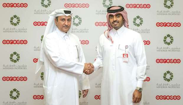 Ooredoo chief business officer Sheikh Nasser bin Hamad bin Nasser al-Thani and Msheireb Properties acting chief officer-Commercial Jamal al-Kuwari shake hands after announcing the agreement.