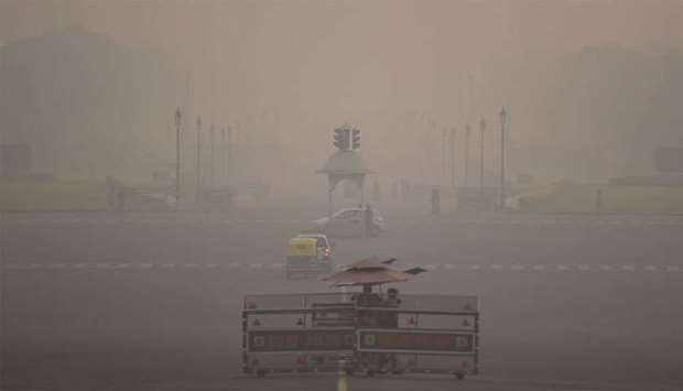 Commuters are seen amid heavy smog in New Delhi