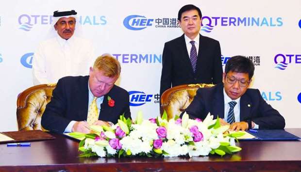 Bissett and Qiaoliang sign the pact as HE Transport and Communications Minister Jassim Seif Ahmed al-Sulaiti and Chinese ambassador Li Chen look on.