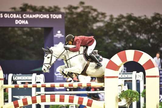 Qataru2019s Bassem Hassan Mohamed astride Argelith Squid clears a hurdle during the CSI 5* Two phases 1.45m class of the Global Champions Tour at Al Shaqab arena yesterday.