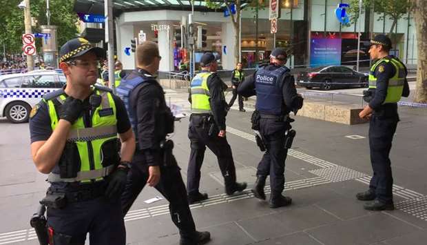 Policemen stop members of the public from walking towards the Bourke Street mall in central Melbourne