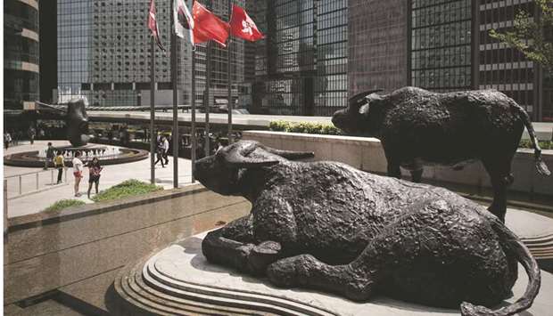 Bull statues displayed outside the Hong Kong Stock Exchange (file). The Hang Seng index closed down 2.4% to 25,601.92 points yesterday.