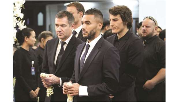This handout photo taken and released by King Power on November 4 shows Leicester Cityu2019s players Danny Simpson (C), Caglar Soyuncu (2nd-R) and other team members paying their respects to Leicester Cityu2019s Thai owner and duty-free mogul, Vichai Srivaddhanaprabha during a funeral ceremony at Wat Thepsirin Buddhist temple in Bangkok. Players and staff from Leicester City will honour Vichai today when the team play Burnley in the Premier League.
