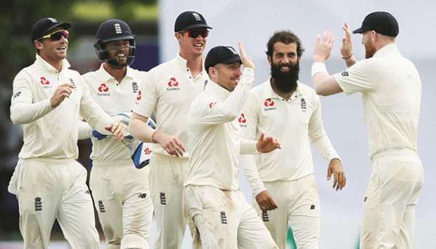 Englandu2019s Moeen Ali (second from right) celebrates with his teammates Ben Stokes (right), Jack Leach (centre), Keaton Jennings (second from left) and Ben Foakes after taking the wicket of Sri Lankau2019s Niroshan Dickwella (not pictured) on Day Four of the first Test in Galle, Sri Lanka, yesterday. (Reuters)