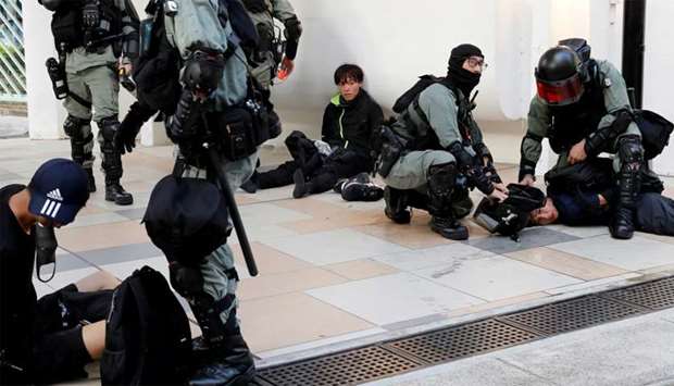 Protesters are detained by riot police officers during an anti-government demonstration in Hong Kong, China