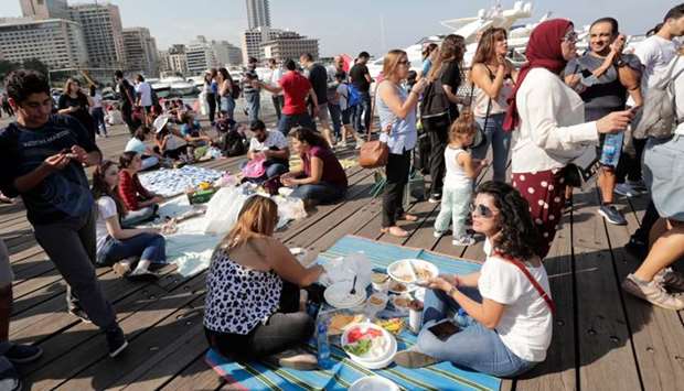 Lebanese demonstrators gather and picnic at Beirut's Zaitunay Bay during a protest against the privatisation of public spaces