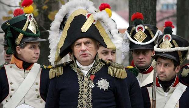 In this file photo taken on October 23, 2005 members of a historical club, dressed as French soldiers and Oleg Sokolov (C) take part in the re-enactment of the 1812 battle between Napoleon's army and Russian troops in the town of Maloyaroslavets