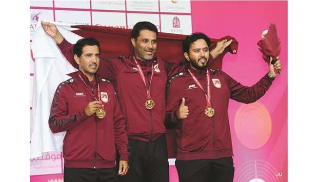 Nasser Saleh al-Attiyah (C) poses with Masoud Hamad and Rashid Hamad after Qatar won the team gold in skeet at the Asian Shooting Championships.  PICTURES: Nasser T K