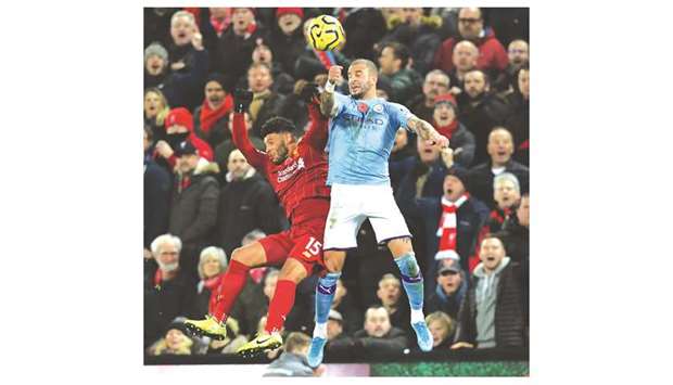 Liverpoolu2019s English midfielder Alex Oxlade-Chamberlain (L) vies with Manchester Cityu2019s English defender Kyle Walker (R) during  their match at Anfield yesterday.