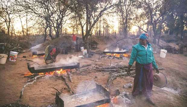 Josephine Macete oversees salt-rich water boiling on the bank of the Klein Letaba River near Baleni, in the South African province of Limpopo.