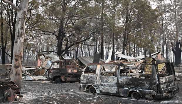 The burnt-out remains of cars and property belonging to Art Murphy and his wife Shirley are seen following bushfires in Old Bar, 350km north of Sydney