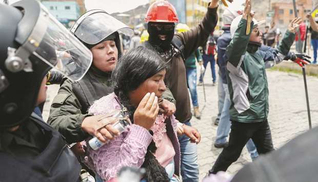 Members of the security forces detain a woman during clashes between supporters of Evo Morales and the opposition in La Paz, Bolivia, yesterday.