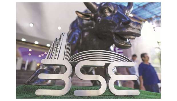 The signage for the Bombay Stock Exchange (BSE) is displayed next to a bronze bull statue at the entrance to the BSE building in Mumbai (file). Asian Paints Ltdu2019s price-to-earnings ratio of 80.1 makes it the highest valued on the S&P BSE Sensex Index. The paint manufacturer has climbed 29% in the last six months u2013 when the broader gauge has gained 6.5% u2013 and has hit a record high in the past month.