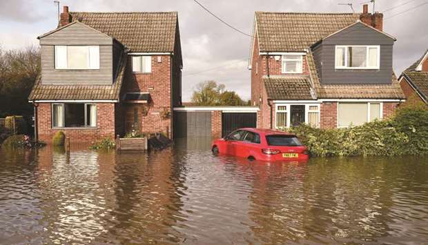 Homes in the village of Fishlake near Doncaster, northern England, yesterday, remained flooded following heavy rains and the River Don bursting its banks.