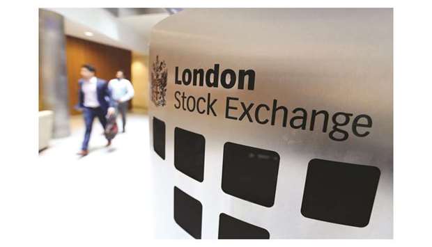Visitors pass a sign inside the London Stock Exchange Group headquarters. The FTSE 100 index closed 0.6% down at 7,359.38 points yesterday.