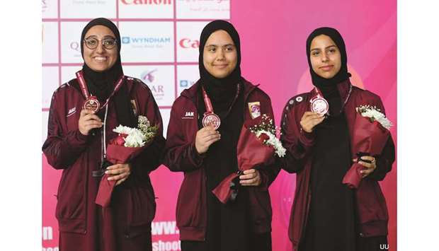 Qataru2019s Fatima Saeed al-Muraikhi, Ghalia Ali al-Malki and Amna Ali al-Shirawi pose with their womenu2019s skeet team bronze.
