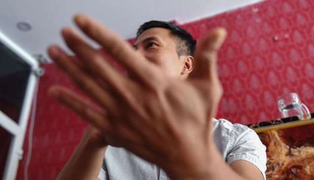 This photograph taken on October 30, shows a Vietnamese migrant, who requested to remain anonymous and was deported from Britain, speaking during an interview with AFP at his home in Vietnam's Nghe An province