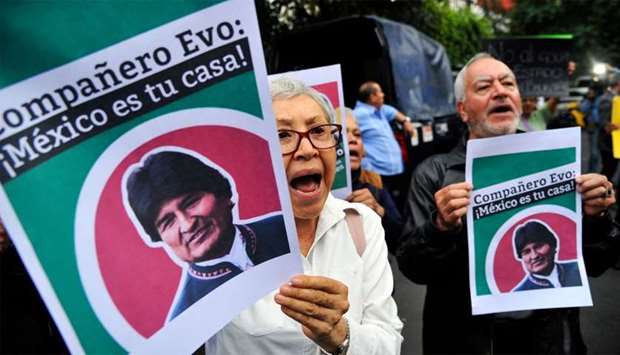 People demonstrate in support of Bolivian ex-President Evo Morales in front of the Bolivian embassy in Mexico City