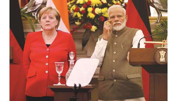 Narendra Modi, Indiau2019s prime minister (right) and Angela Merkel, Germanyu2019s chancellor, at a press conference, in New Delhi. India has invited German companies to invest in the northern state of  Uttar Pradesh and in Tamil Nadu where it is setting up two defence industrial corridors, Modi said.