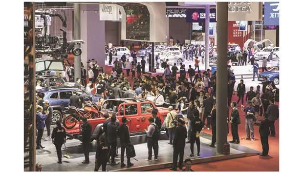 Attendees walk through Fiat Chrysler Automobilesu2019 Jeep booth at the Auto Shanghai 2019 show in Shanghai on April 18. PSA does not have enough competitive SUV models, and neither company has enough electric and plug-in hybrid vehicles, or enough cars packed with hi-tech features for Chinese tastes, analysts say.